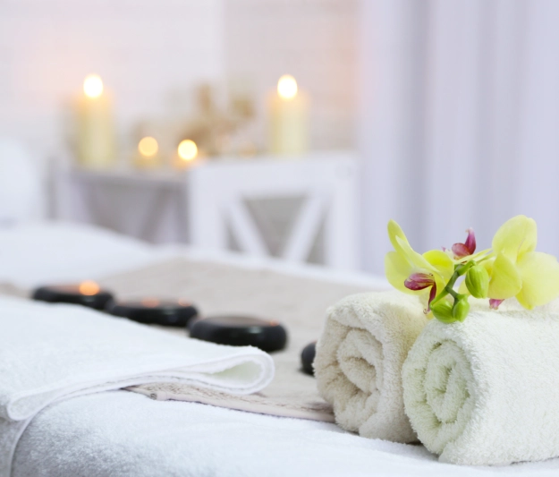 massage table with hot stones and candle light